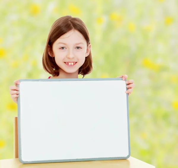 Little girl holding white poster. — Stock Photo, Image