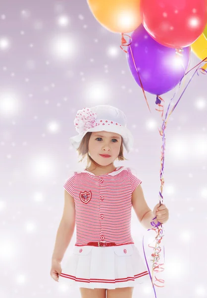 Girl holding balloons — Stock Photo, Image