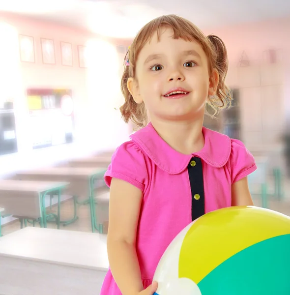 Little girl with striped ball — Stock Photo, Image