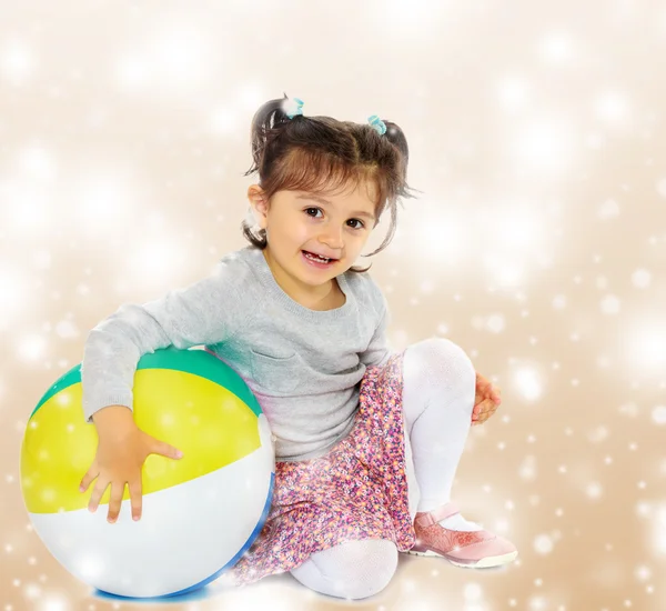 Little girl hugging a big ball — Stock Photo, Image