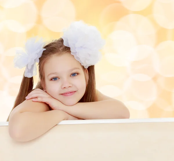 Beautiful little girl with white bows on the head — Stock Photo, Image