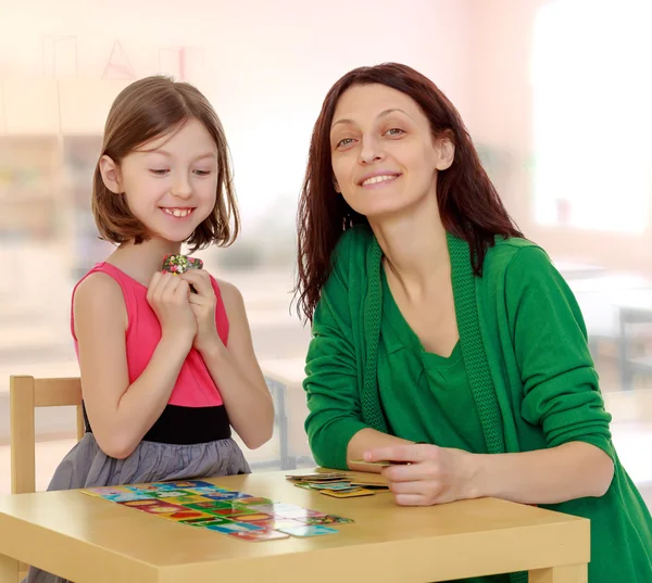 Maman et fille à la table jouant à des jeux éducatifs — Photo