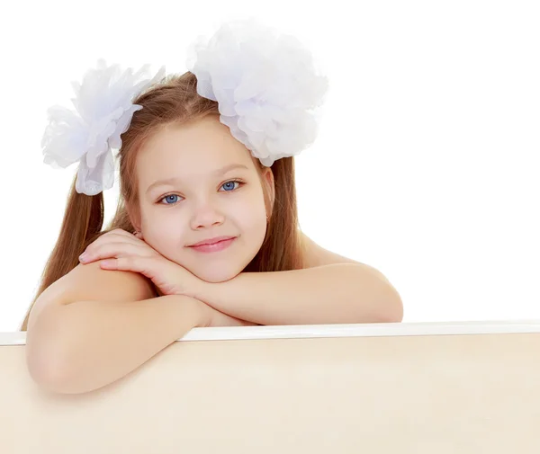 Beautiful little girl with white bows on the head — Stock Photo, Image