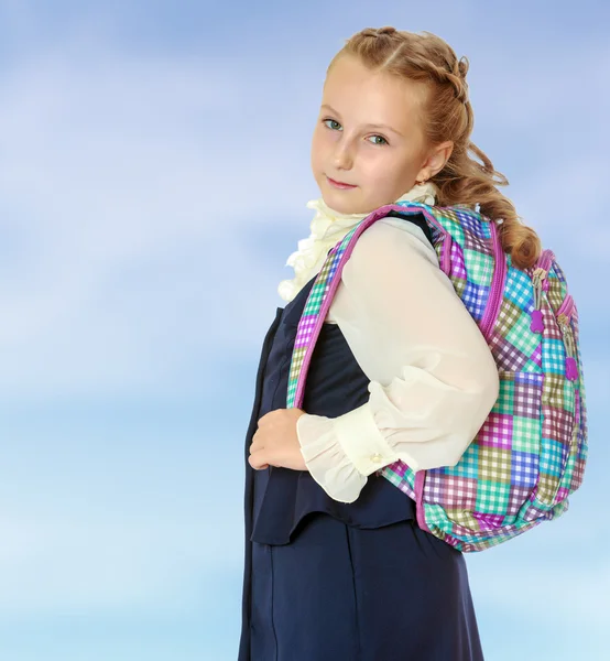 Beautiful girl schoolgirl with a satchel on his shoulders. — Stock Photo, Image