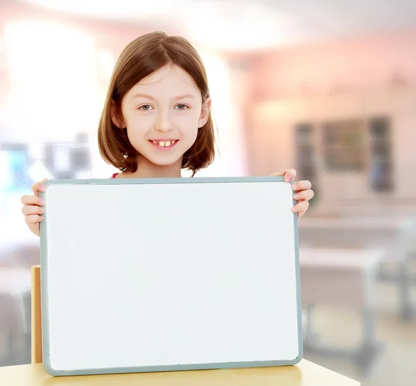 Little girl holding white poster. — Stock Photo, Image