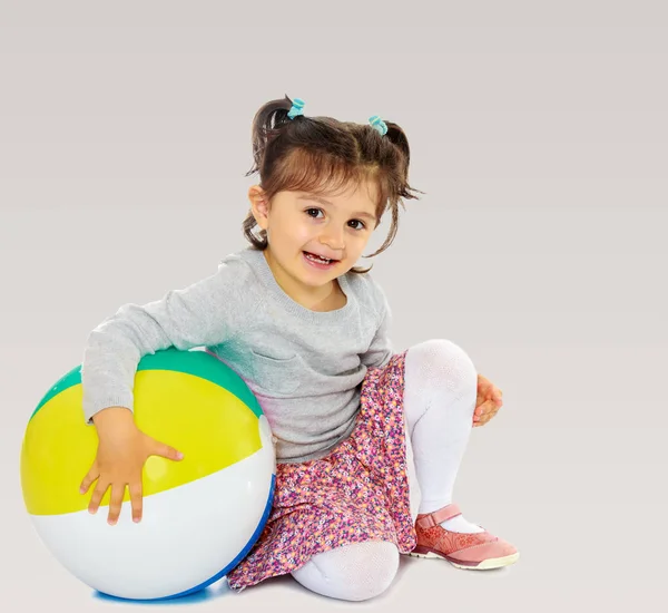 Little girl hugging a big ball — Stock Photo, Image