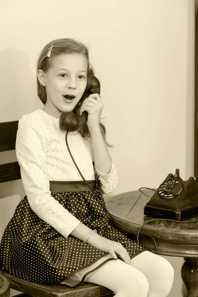 La fille dit dans le téléphone vieux téléphone — Photo