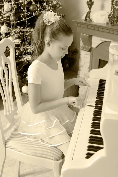 A menina pressiona as teclas do piano . — Fotografia de Stock