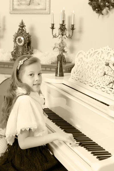 Flickan pressar stämm av pianot. — Stockfoto
