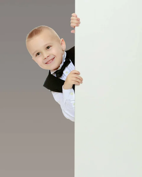 Boy peeks out from behind the banner — Stock Photo, Image