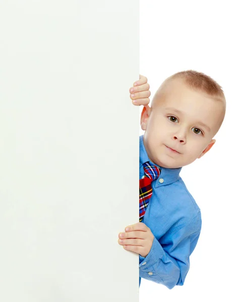 Boy peeks out from behind the banner Royalty Free Stock Images