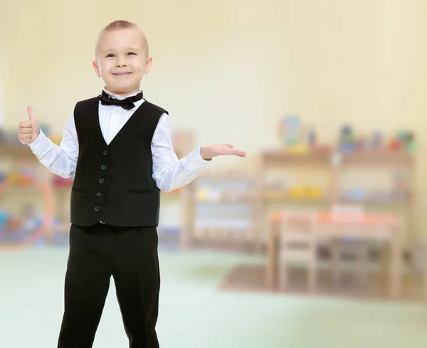 Trendy little boy in a black suit with a tie. — Stock Photo, Image