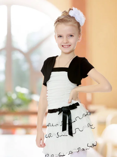 Piękna mała dziewczynka w biały, Krótka sukienka z czarny pas. — Zdjęcie stockowe