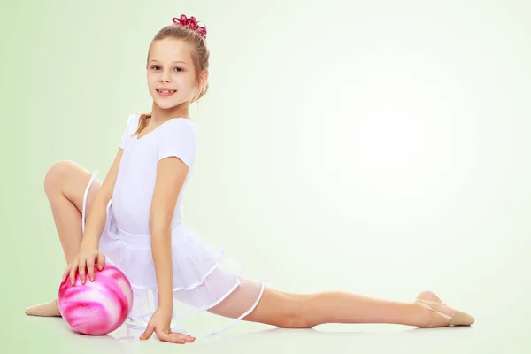 Gymnast does exercises with a ball — Stock Photo, Image