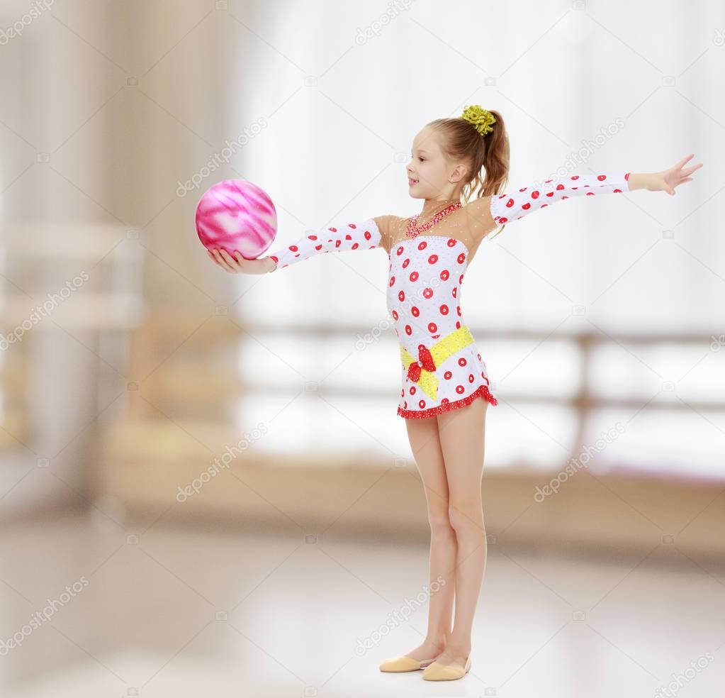 Gymnast does exercises with a ball