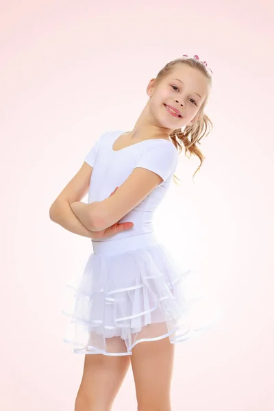 Girl gymnast in a white tracksuit. — Stock Photo, Image