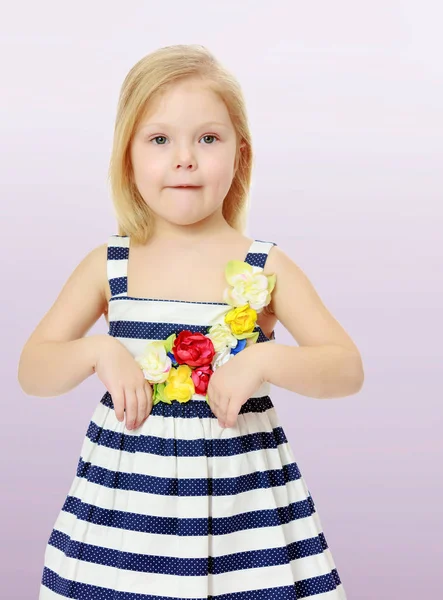 Little girl in a striped dress. — Stock Photo, Image