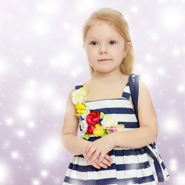 Little girl in a striped dress. — Stock Photo, Image