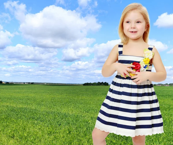 Little girl in a striped dress. — Stock Photo, Image