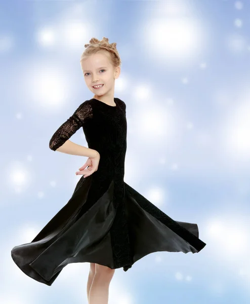 Beautiful little dancer in a black dress. — Stock Photo, Image