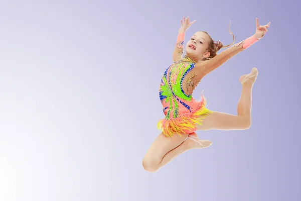 Girl gymnast performs a jump. — Stock Photo, Image