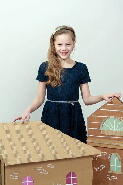 Girl playing in a cardboard house. — Stock Photo, Image