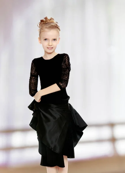 Beautiful little dancer in a black dress.