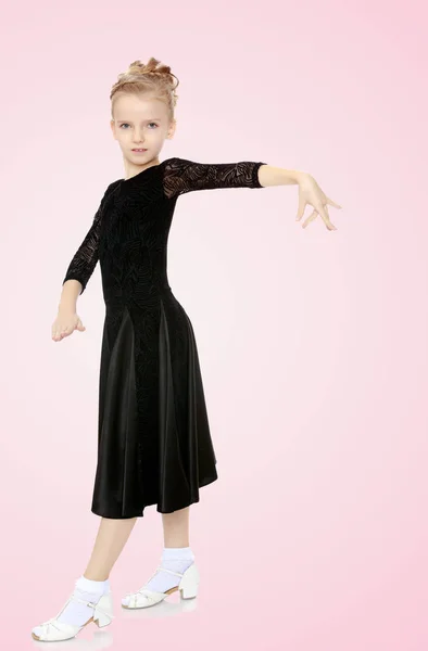 Beautiful little dancer in a black dress. — Stock Photo, Image