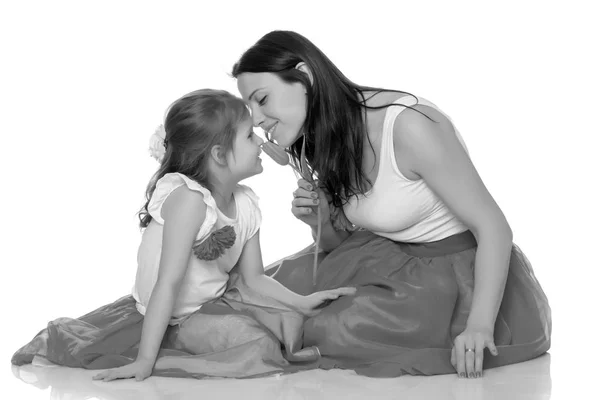 Mom and daughter with a flower of tulip. — Stock Photo, Image