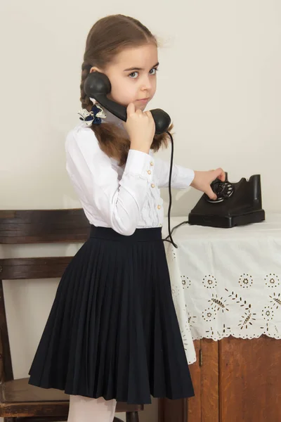 The girls ringing on the old phone. — Stock Photo, Image