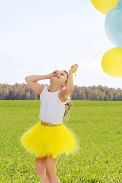 Little girl with balloons in his hands . — Stock Photo, Image