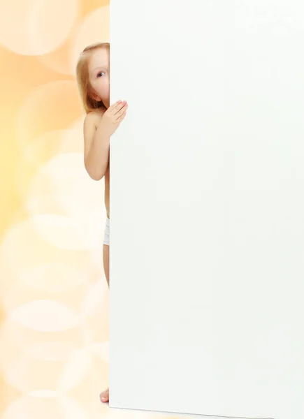 A little girl peeks out from behind the banner. — Stock Photo, Image