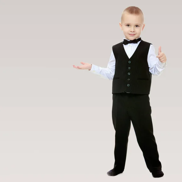 Trendy little boy in a black suit with a tie. — Stock Photo, Image