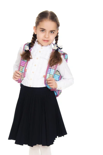 Beautiful schoolgirl with a backpack behind her shoulders. — Stock Photo, Image