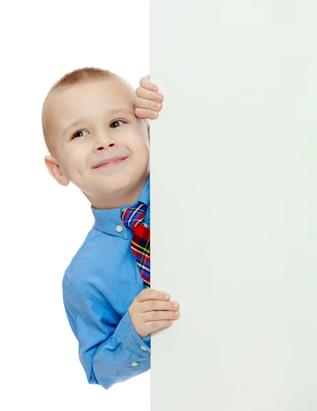 Boy peeks out from behind the banner Stock Image