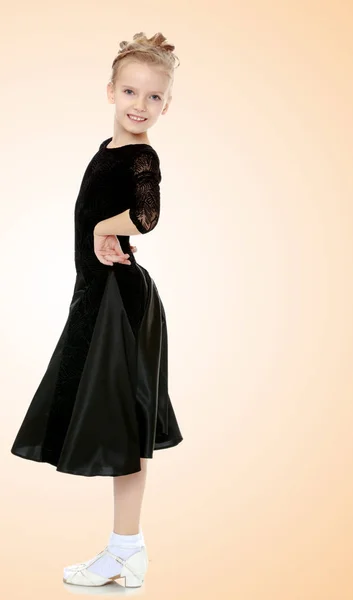 Beautiful little dancer in a black dress. — Stock Photo, Image