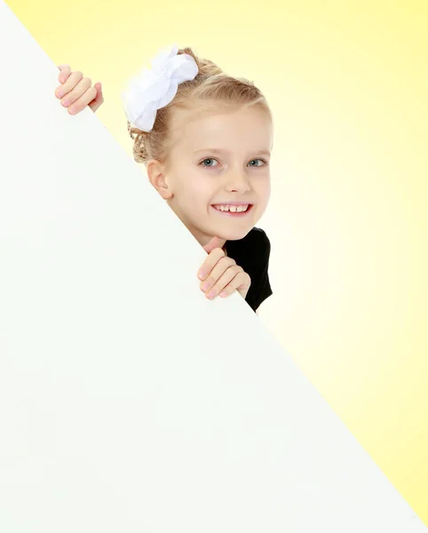 A menina espreita por trás da bandeira branca . — Fotografia de Stock