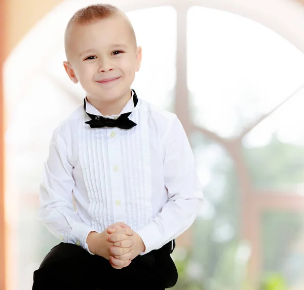 Kleine jongen in een wit overhemd en stropdas. — Stockfoto