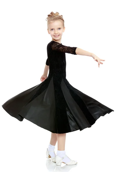 Beautiful little dancer in a black dress. — Stock Photo, Image