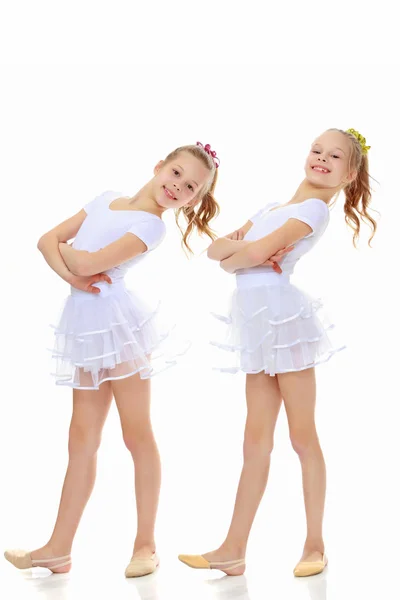 2 girls gymnast in white suits. — Stock Photo, Image