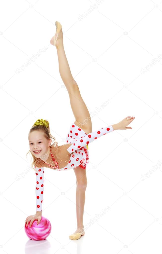Gymnast does exercises with a ball