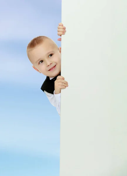 Boy peeks out from behind the banner Stock Photo
