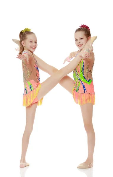 Two girls gymnast sitting on splits. — Stock Photo, Image