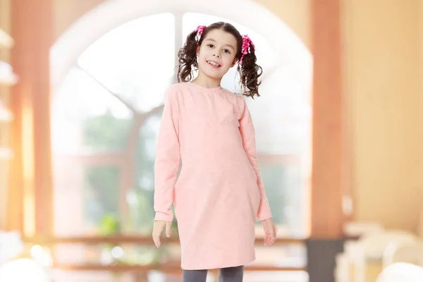 Beautiful little girl in a pink dress. — Stock Photo, Image