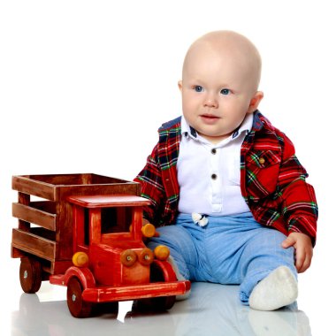 Küçük bir çocuk oyuncak bir arabayla oynuyor..