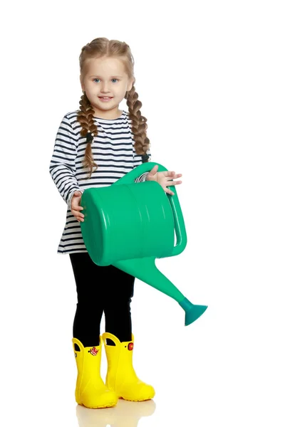 A little girl is watering a garden. — Stock Photo, Image