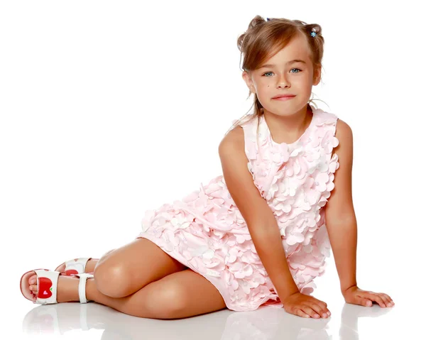 Little girl is sitting on the floor. — Stock Photo, Image