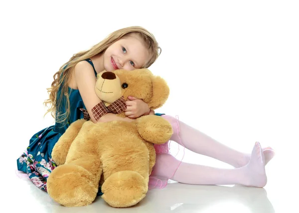 Beautiful little girl with long blond hair in a smart blue dress — Stock Photo, Image