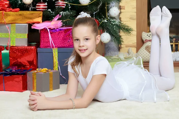 Little girl with gifts by the Christmas Tree — Stock Photo, Image