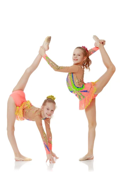 Two girls gymnast sitting on splits. — Stock Photo, Image
